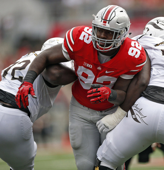 Ohio State Buckeyes defensive lineman Adolphus Washington (92) gets past Western Michigan Broncos offensive lineman Taylor Moton (72) and Western Michigan Broncos offensive lineman Chukwuma Okorafor (77) in the 1st quarter of their game at Ohio Stadium on September 26, 2015. (Dispatch photo by Kyle Robertson)